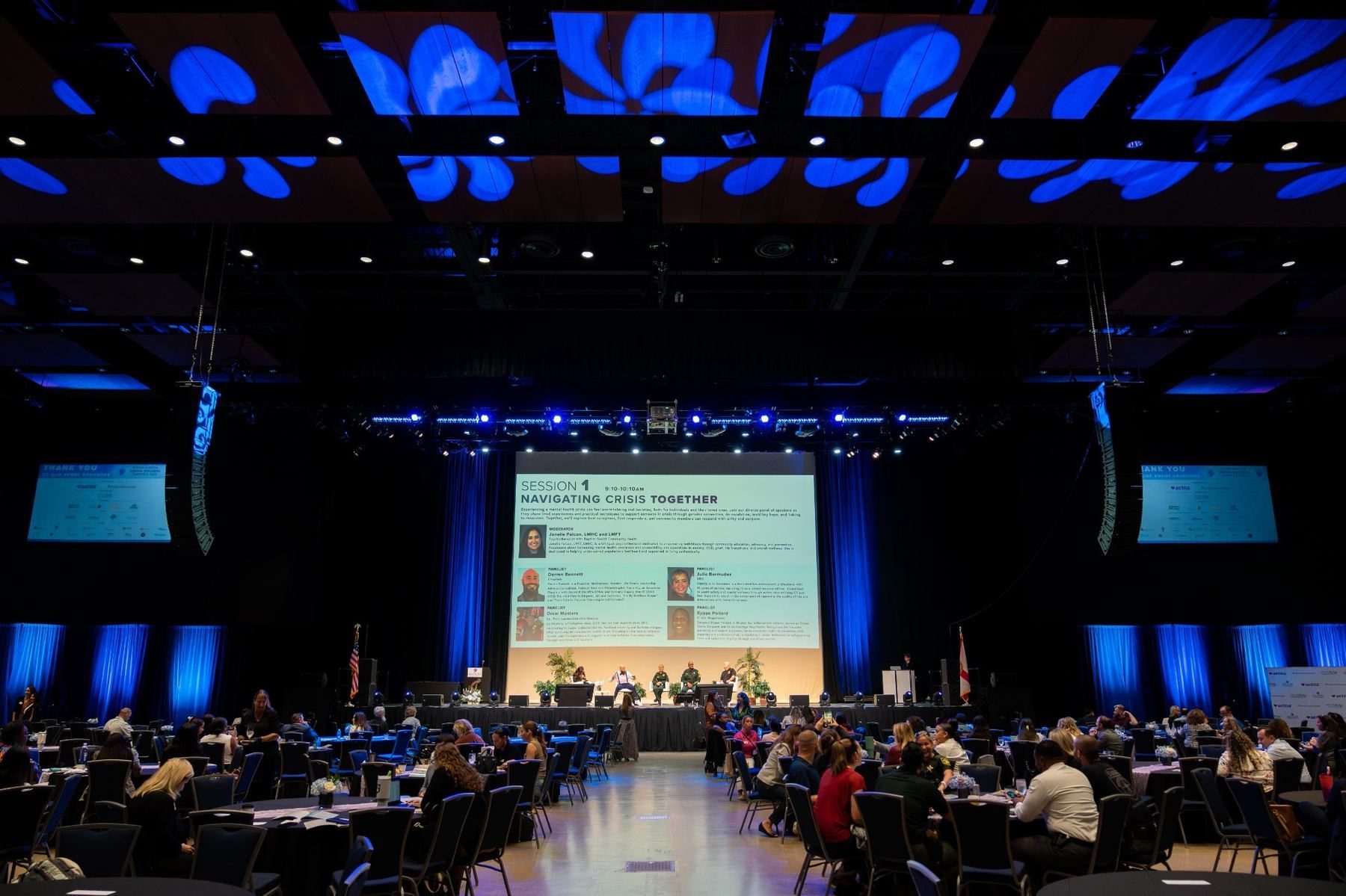 Community exhibitor greeting attendees