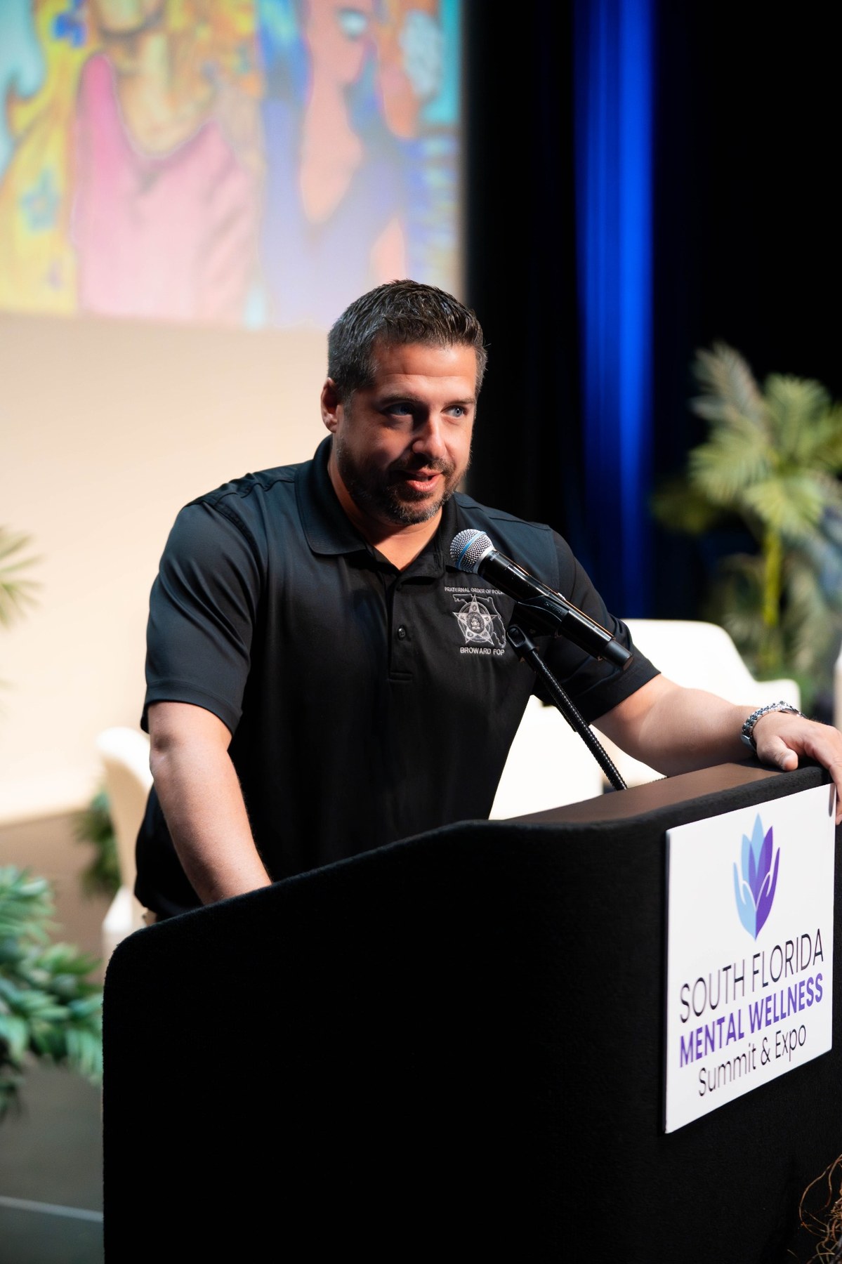 Speaker at podium with summit logo